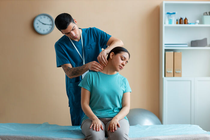 A medical professional performs a neck adjustment, showcasing serious issues medical professionals treated.