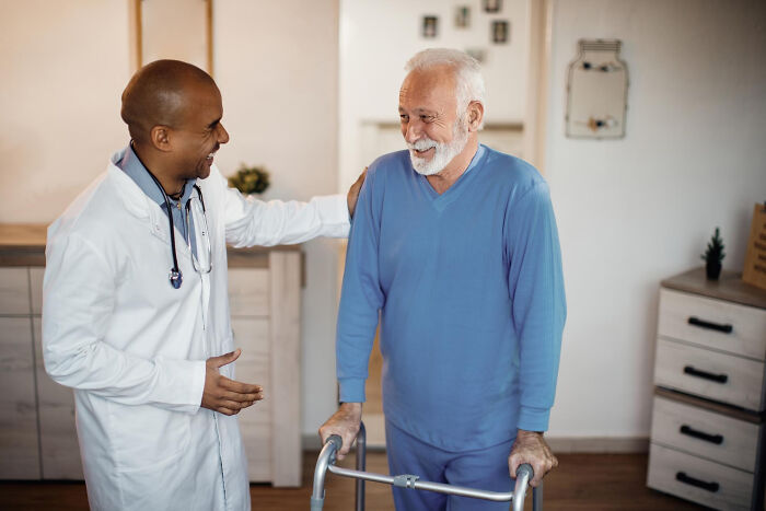 Medical professional assisting an elderly man with a walker, addressing serious issues from an innocent start.
