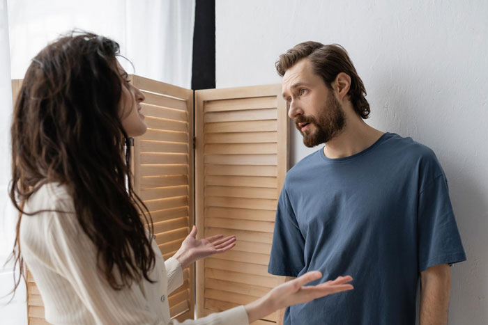 A woman gesturing while arguing with her jobless BF about financial advice.
