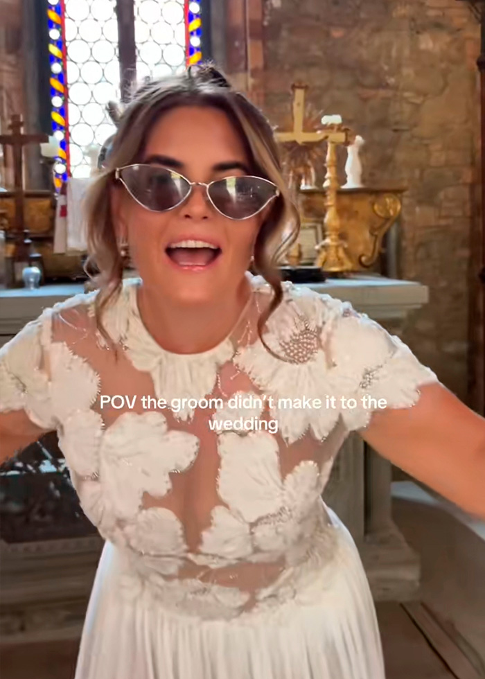 A happy bride in a white wedding dress and sunglasses in a church, enjoying her destination wedding without the groom. A happy bride in a white wedding dress and sunglasses in a church, enjoying her destination wedding without the groom.