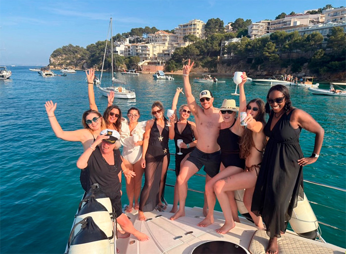 A group of friends celebrating on a yacht at a destination wedding, after the bride was dumped. A group of friends celebrating on a yacht at a destination wedding, after the bride was dumped.