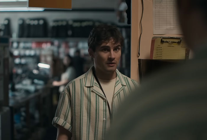 Man speaking in a dimly lit room related to obsession theme