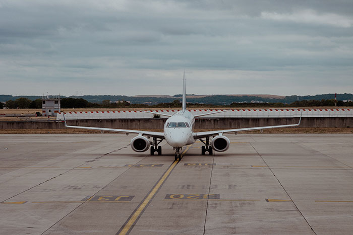 Airplane on an airport runway, reflecting the airport built around graves and its unique history Airplane on an airport runway, reflecting the airport built around graves and its unique history