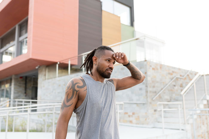 A man turned away by a realtor because he allegedly wouldn’t fit the neighborhood, looking pensive. A man turned away by a realtor because he allegedly wouldn’t fit the neighborhood, looking pensive.