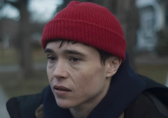 Trans actor Elliot Page exposing Hollywood's bleak reality after massive The Odyssey success, wearing a red beanie. Trans actor Elliot Page exposing Hollywood's bleak reality after massive The Odyssey success, wearing a red beanie.