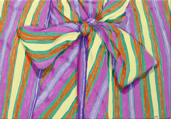 Colorful striped top with a large tied bow, part of a striking portrait of identity.