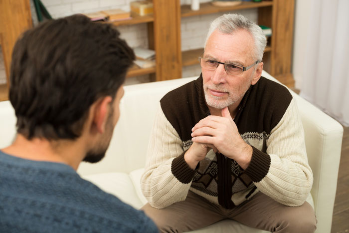 A father and son discussing freeloading plan for free housing to save for a future.