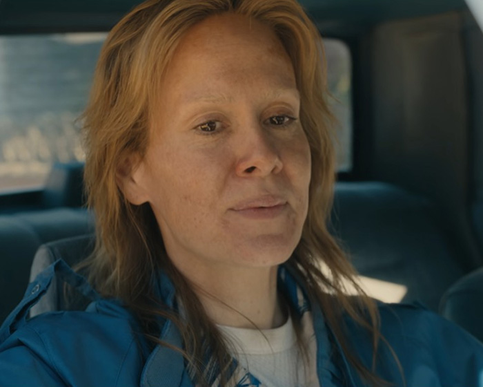 Sarah Paulson as the disturbing criminal, sitting inside a vehicle with a serious look Sarah Paulson as the disturbing criminal, sitting inside a vehicle with a serious look