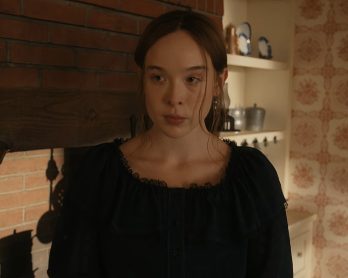 Actress portraying Lizzie Borden, the disturbing criminal, in a dark dress. Actress portraying Lizzie Borden, the disturbing criminal, in a dark dress.