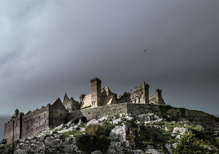 A historical facts ancient castle on a hill under a cloudy sky, representing historical facts.