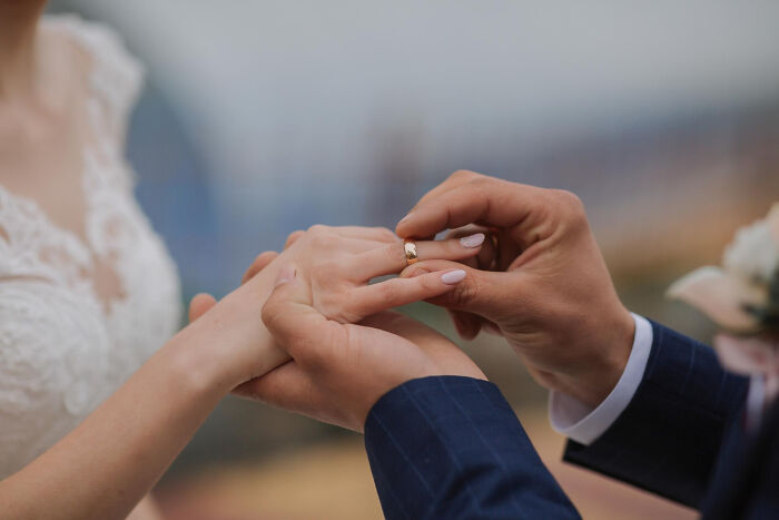 Historical facts: A groom placing a wedding ring on a bride's finger, a tradition with many made-up beliefs.
