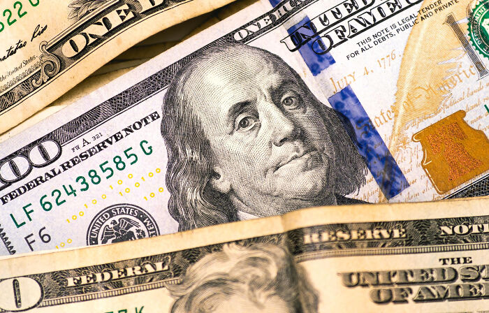 Close-up of historical facts one hundred dollar bills, highlighting historical facts.
