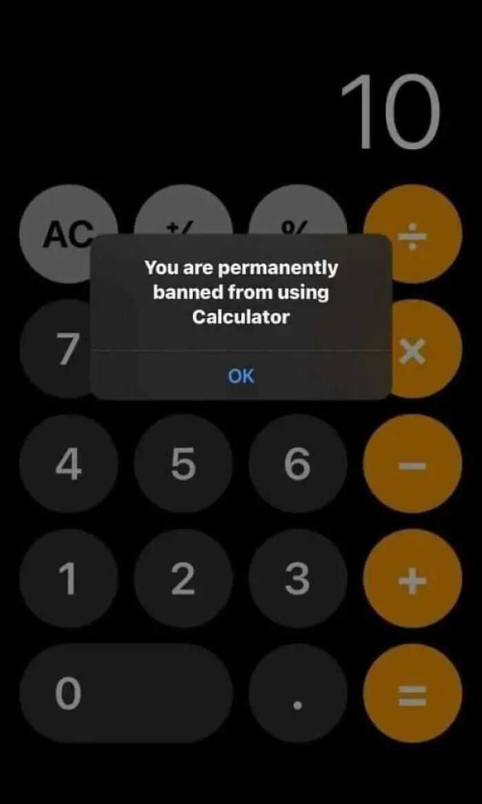 An unhinged image of a calculator showing a pop-up message: You are permanently banned from using Calculator.