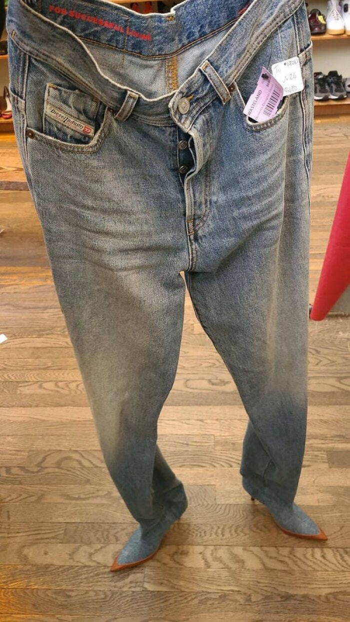 Jeans worn over denim high heel boots creating a confusing optical illusion of legs.