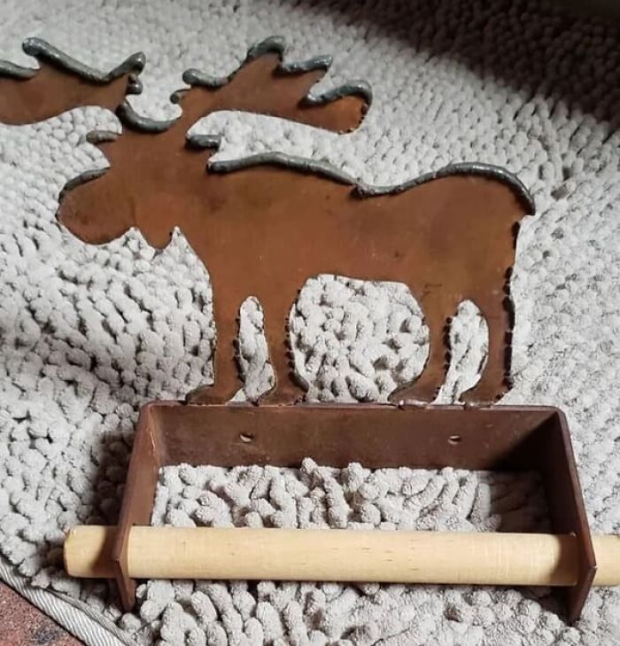 Metal moose-shaped paper towel holder, making you look twice at its unusual shape and texture.