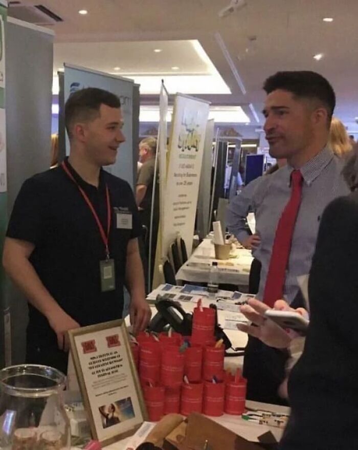 Optical illusion of a man with two heads at a convention