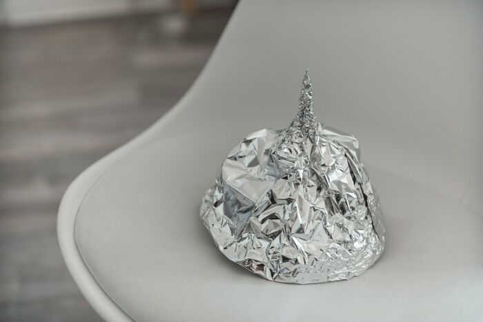 A tin foil hat sitting on a chair, symbolizing bizarre ideas from male coworkers.