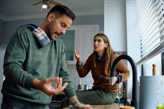 An angry couple arguing in the kitchen, showing unsettling things in relationships.