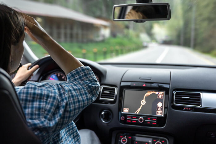 Stressed woman driving, showing the weight of creepy things people did to a partner.