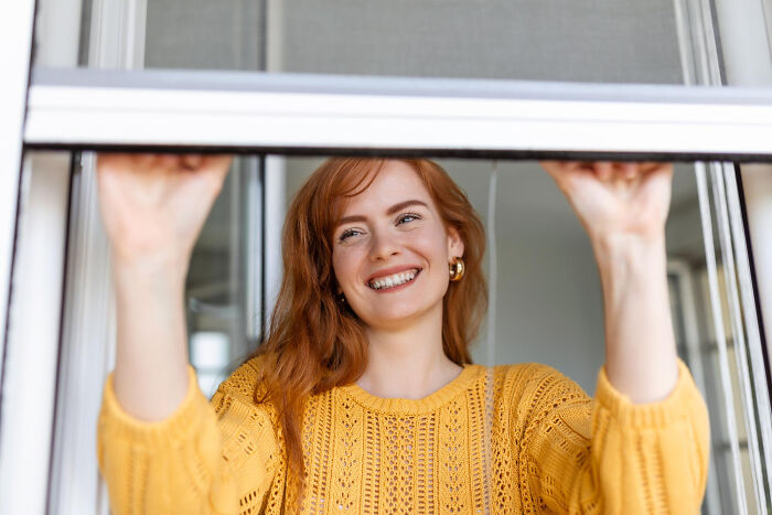 A smiling red-haired woman peers out, hinting at creepy things people did to a partner.
