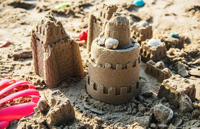 Detailed sandcastle with seashells on beach vacation