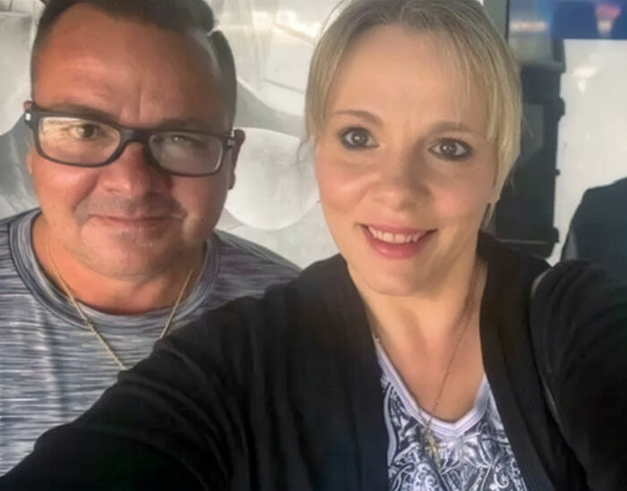 Man and woman, owners of the $450K home seized by HOA over less than $1K debt, smiling