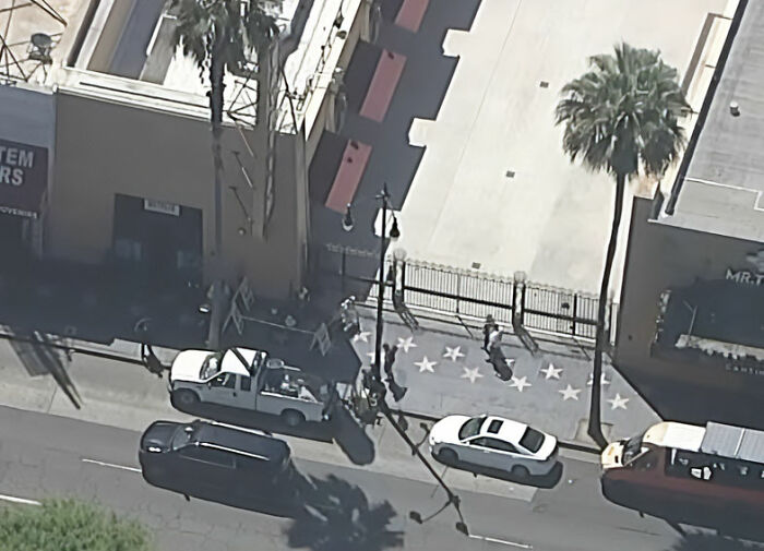 An aerial view of the Hollywood Walk of Fame with a star covered, showing disrespect for Dolly Parton after her passing. An aerial view of the Hollywood Walk of Fame with a star covered, showing disrespect for Dolly Parton after her passing.