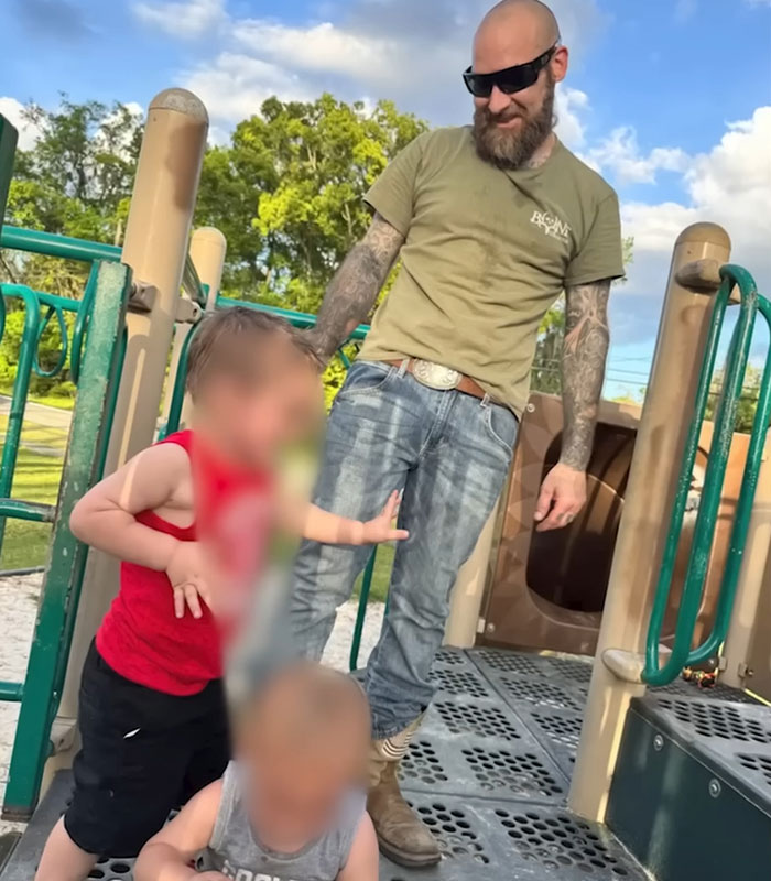 A man with tattoos and children on a playground, representing the children's mother as his attacker. A man with tattoos and children on a playground, representing the children's mother as his attacker.