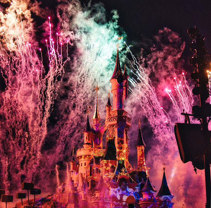 A fairytale castle illuminated by a dazzling fireworks display, evoking wild plot twists from people's lives.