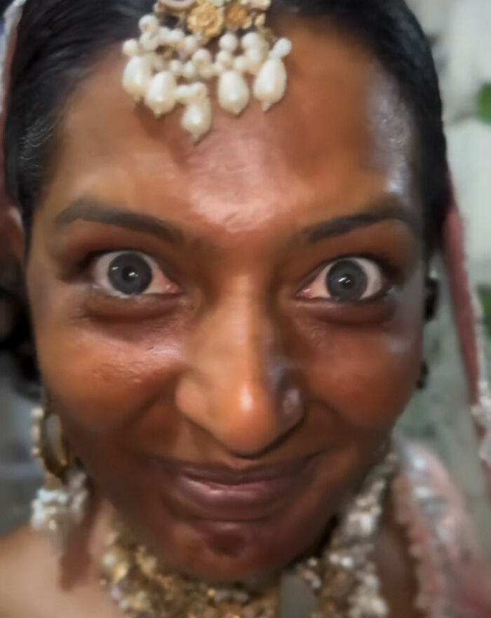 A woman with wide eyes and makeup, part of a dramatic wedding day transformation. A woman with wide eyes and makeup, part of a dramatic wedding day transformation.