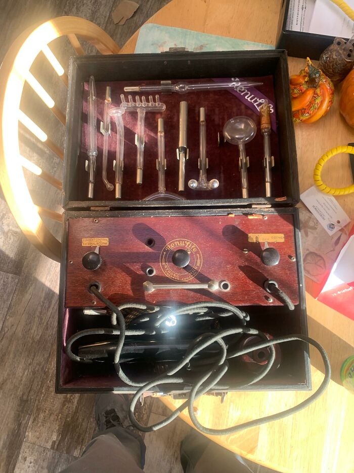 An antique Renulife violet ray machine in its original wooden box from medical history.