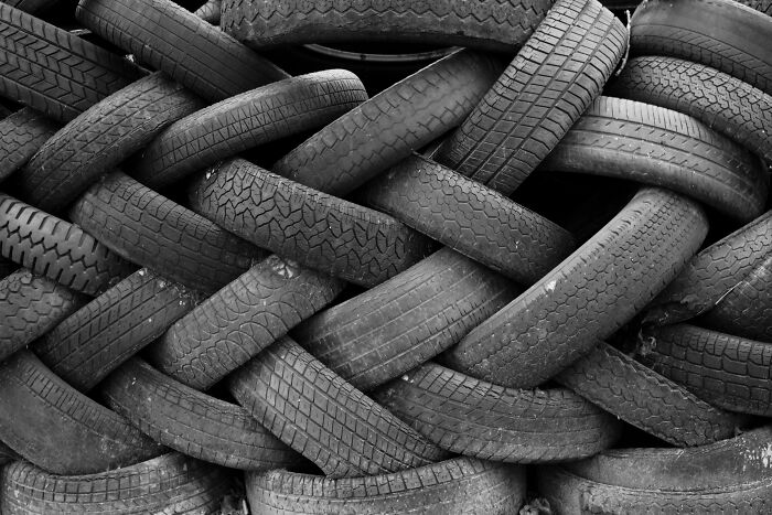 A wall of interwoven old tires, reflecting the dirty truths that industry insiders must get used to.