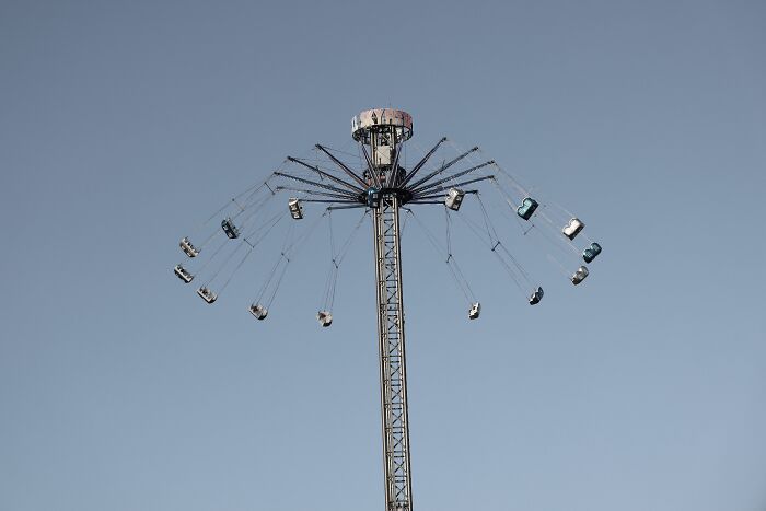 A tall swing ride against a clear sky, an image of fun that may hide some dirty truths industry insiders are used to.