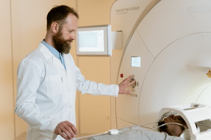 A doctor operating an MRI machine with a patient, reflecting dirty truths in medical industry.
