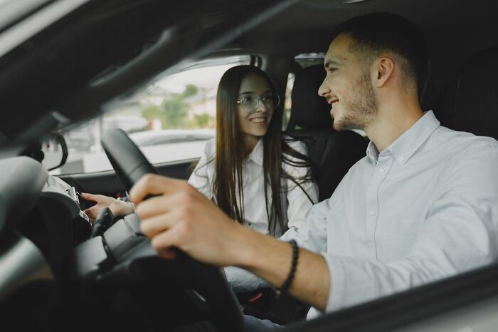 Young couple smiling in car, showing connection despite family cut off