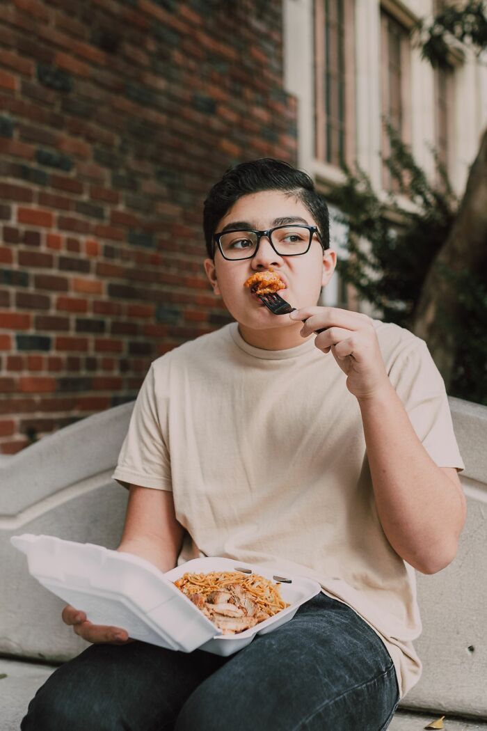 Teen eating takeout alone outside, illustrating family cut off experiences