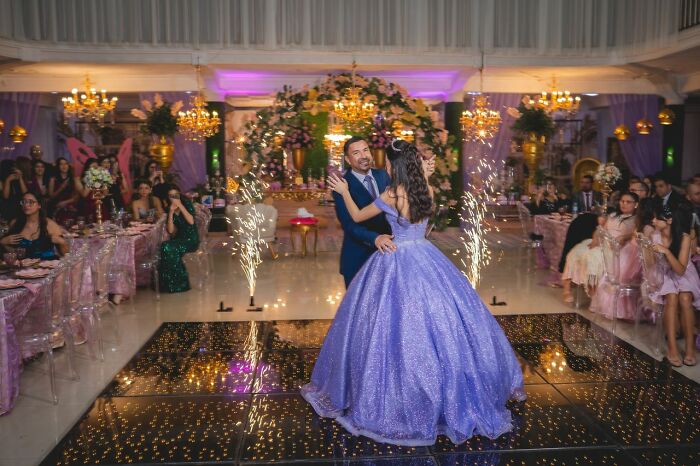 Elegant quinceanera dance at party showing emotional family cut off moments