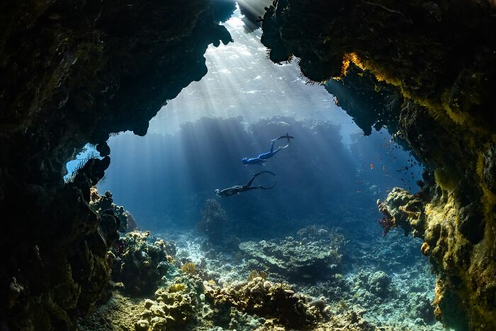 A diver reveals the truth about a mysterious blacked-out island while freediving in a sunlit underwater cave.