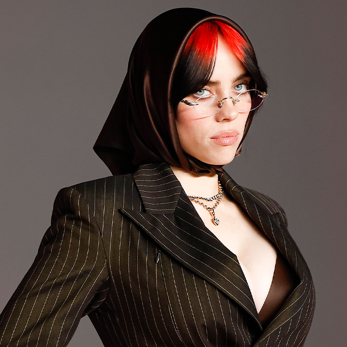 Billie Eilish posing with glasses and a black headscarf