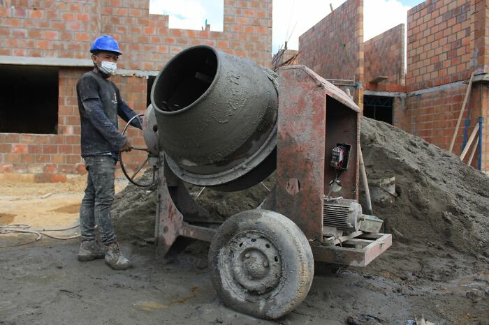 A construction worker with a cement mixer, symbolizing a person whose actions might lead to a patient scenario.