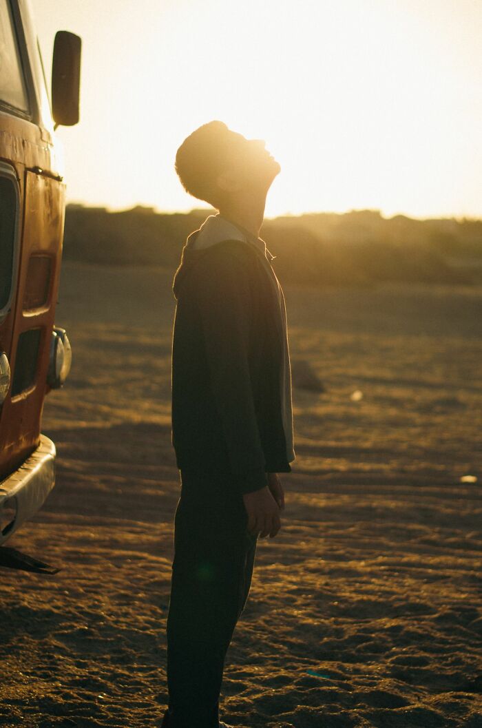 A person looking up at the sky during sunset, representing how some patients misunderstand medical advice.
