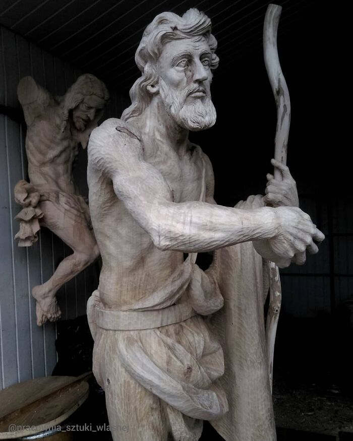 Lifelike wood sculpture of Saint John the Baptist holding a staff by a Polish artist