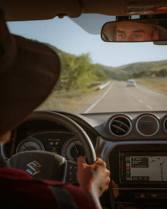 A man driving a car on an open road, pondering what makes men lose interest in a partner