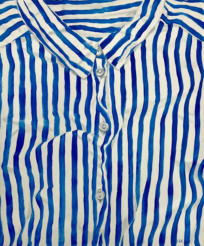 Striking portrait of identity featuring a white shirt with blue vertical stripes and buttons.