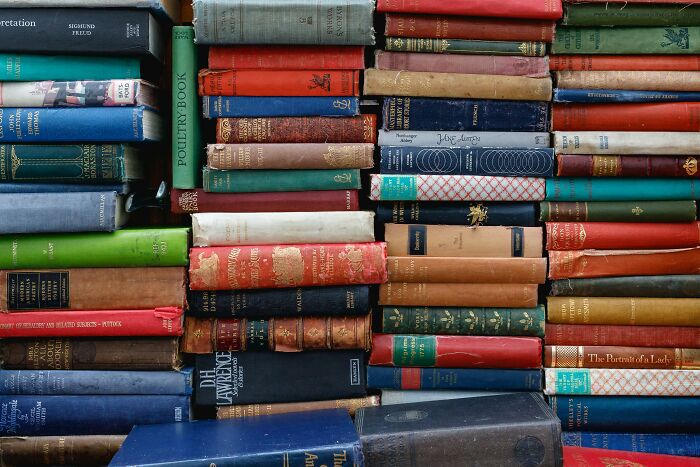 A stack of colorful, old books, representing accumulated industry knowledge and secrets.