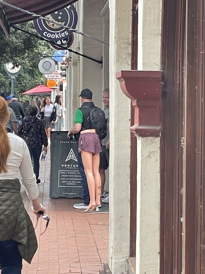 An optical illusion of a man appearing to wear short pink shorts, making you look twice.