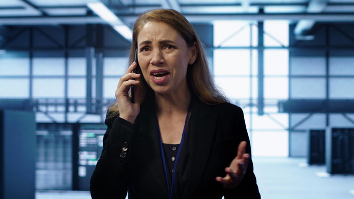 Woman in office speaking on phone about team area policy