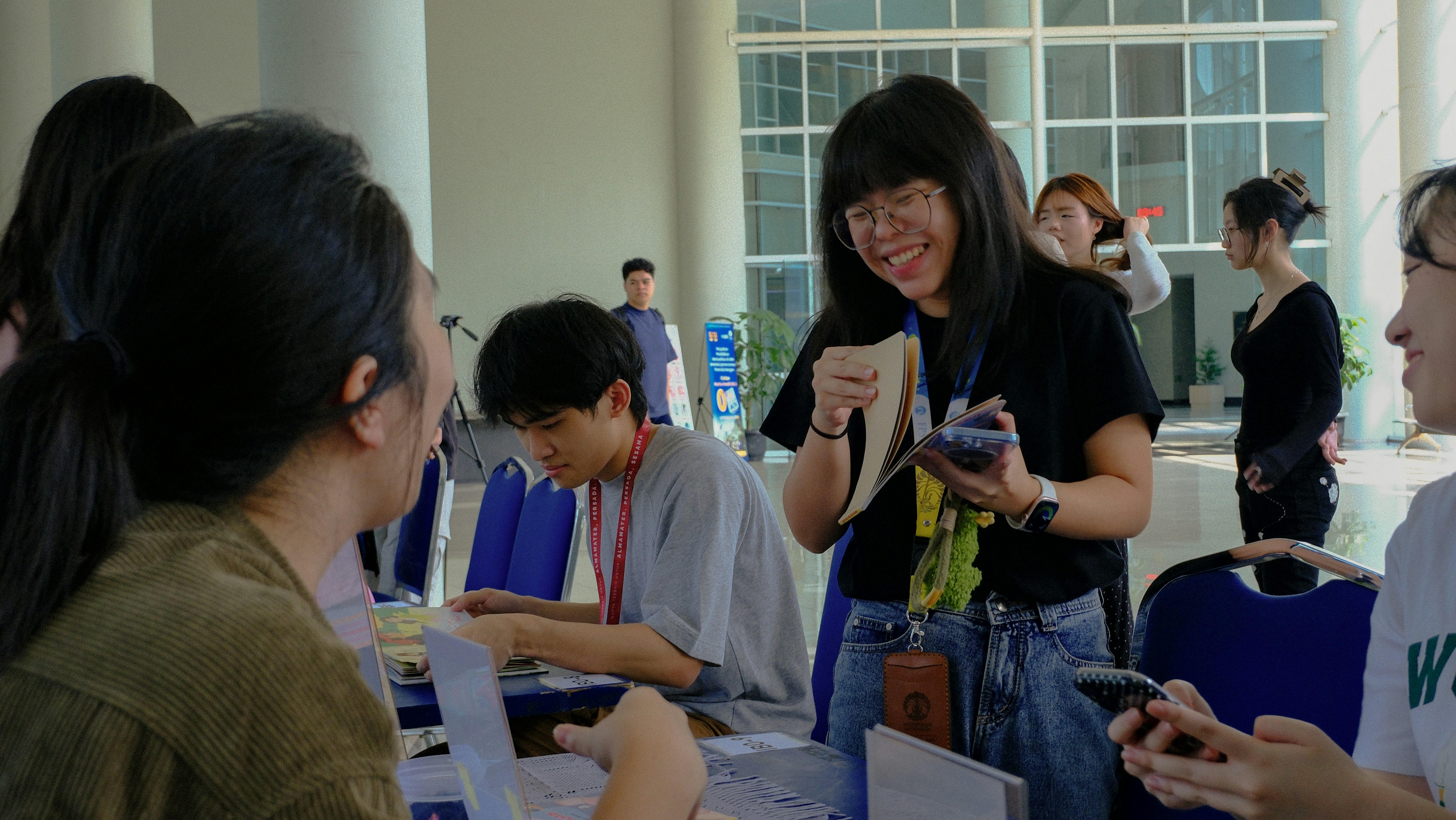 Group of young people interacting happily at a school fundraiser event
