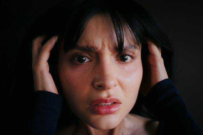 A distressed woman with tears in her eyes, illustrating the impact of crazy lies men told them.