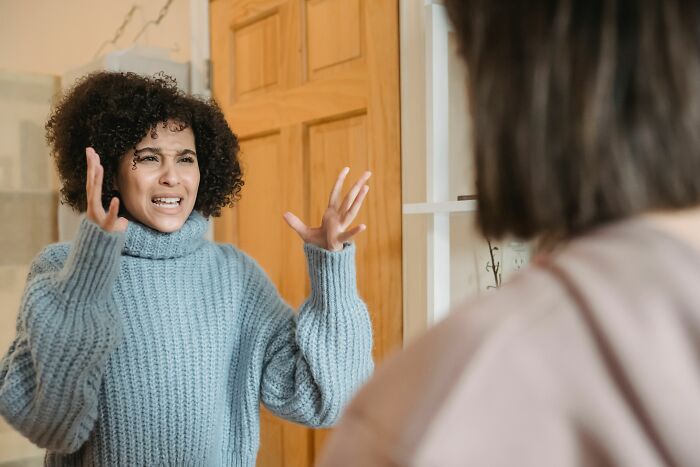 A woman expressing anger during a heated argument with her partner about a divorce split